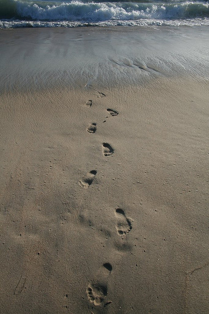 Footprints being washed away
